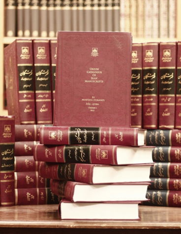 a-stack-of-red-books-sitting-on-top-of-a-wooden-table.jpg a stack of red books sitting on top of a wooden table